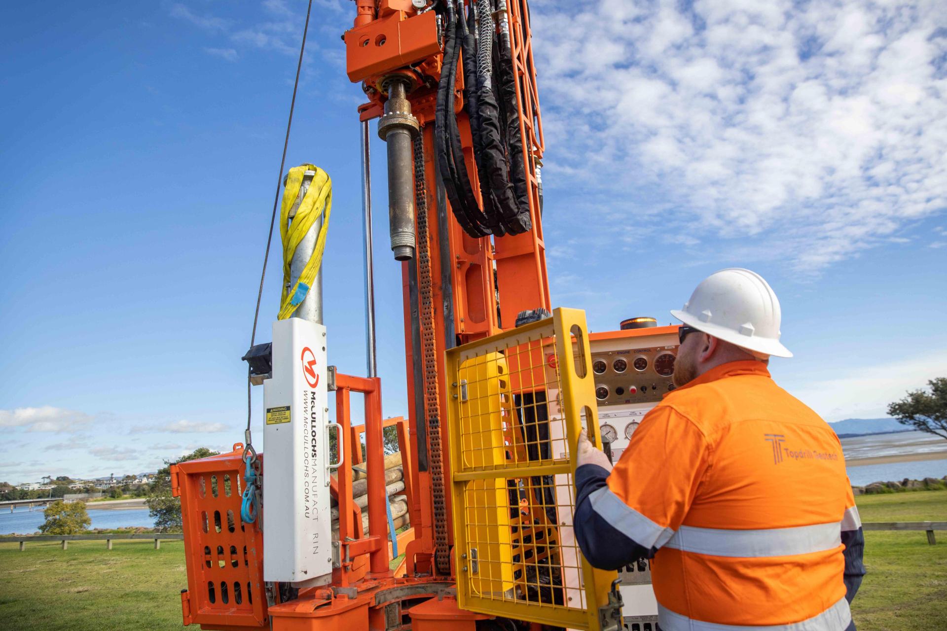 Man operating borehole drilling machine