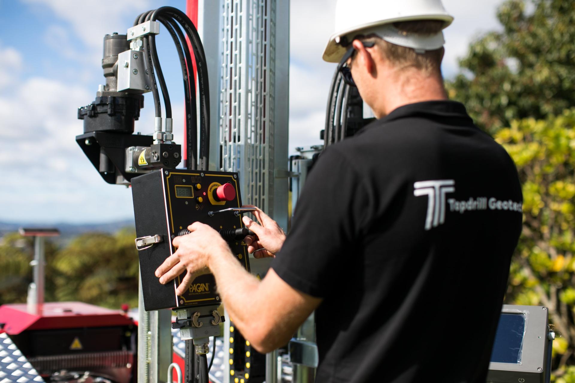 Back shot of man operating CPT machine