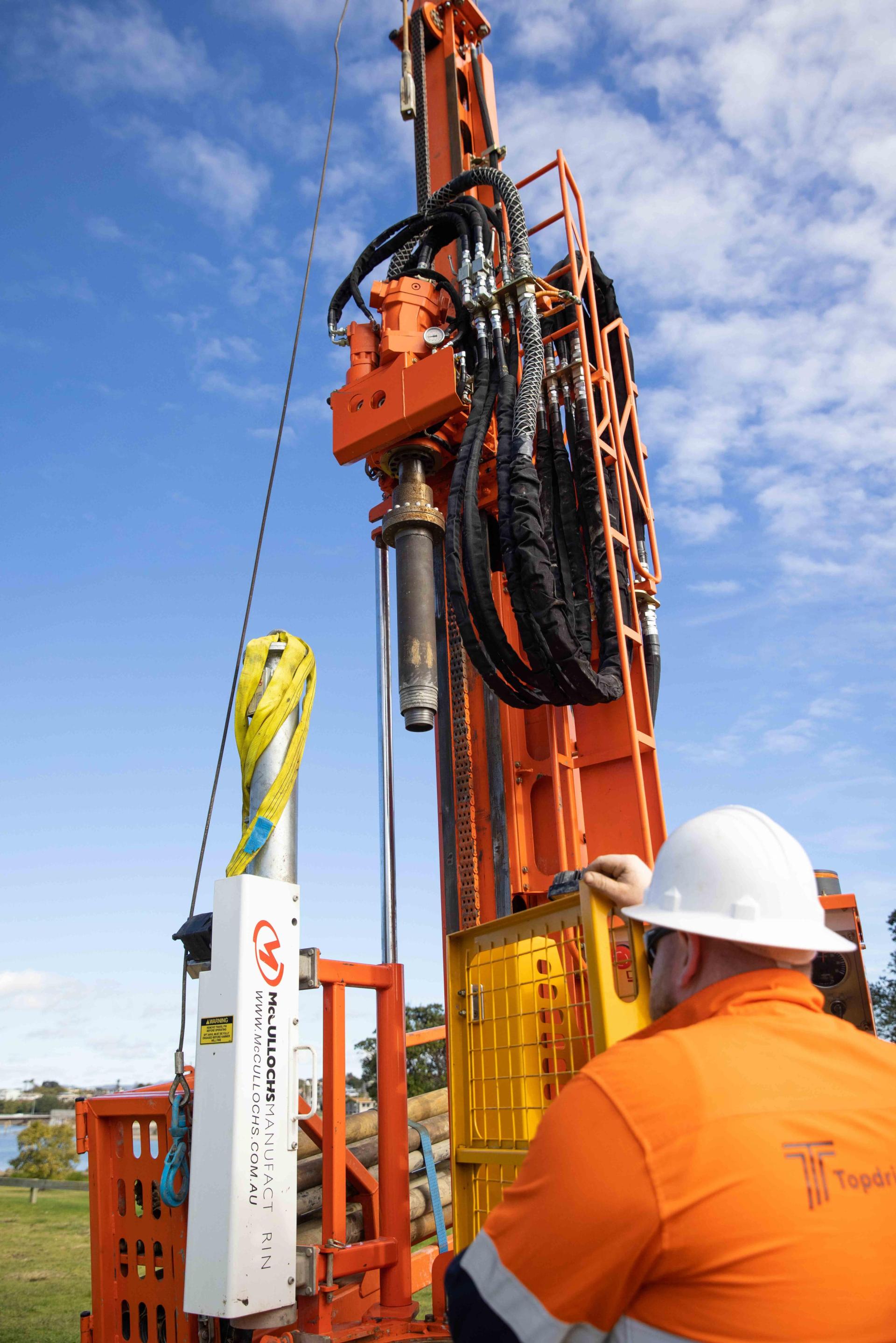 Close up of man operating borehole drilling machine