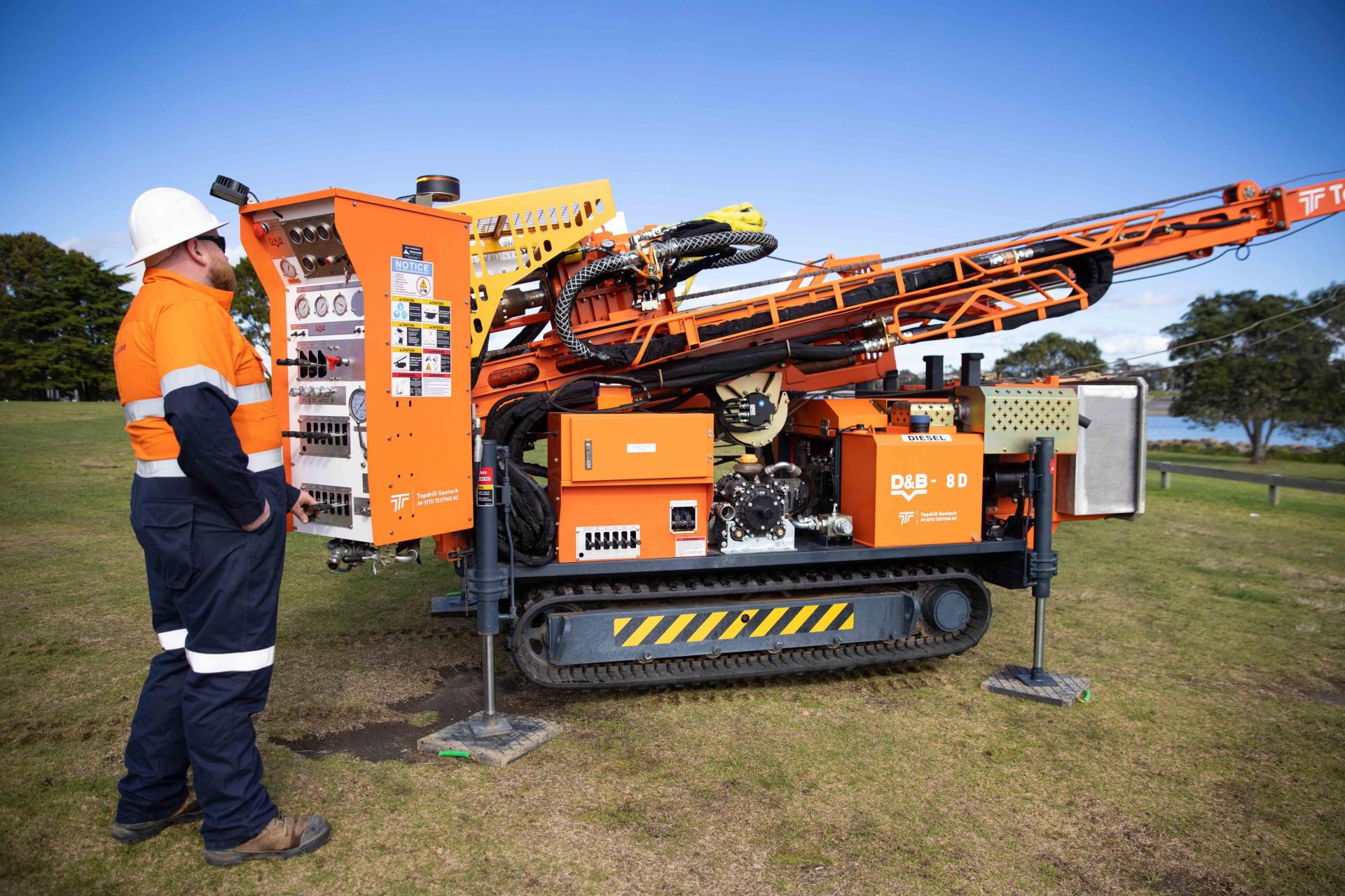 A Borehole Drilling machine, with a man operating the control panel.