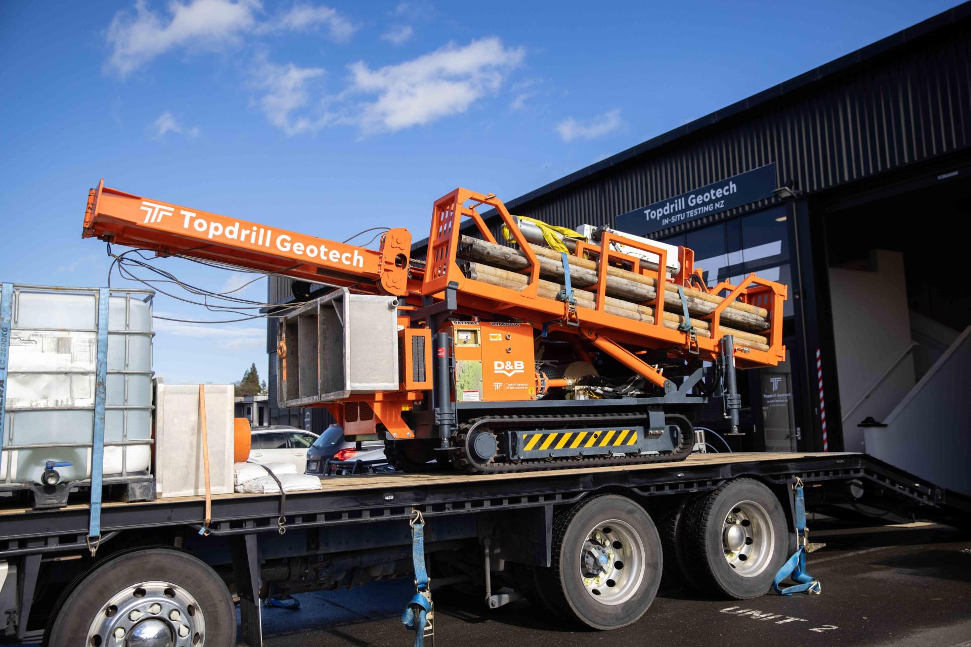 Borehole drilling machine loaded on truck. 