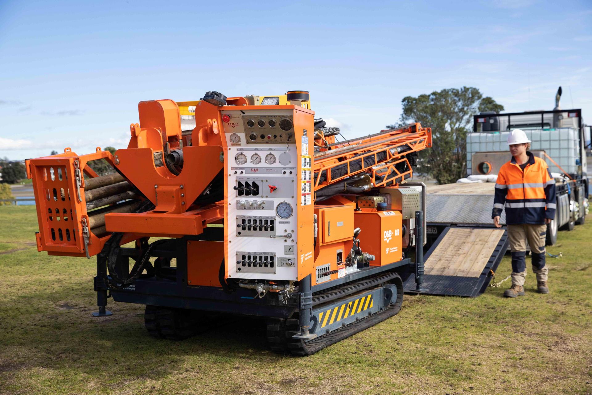 Borehole drilling machine being unloaded from truck