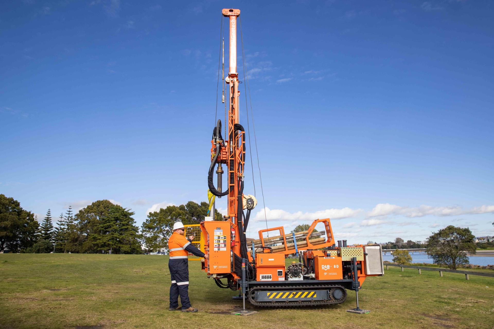 Man operating borehole drilling machine 